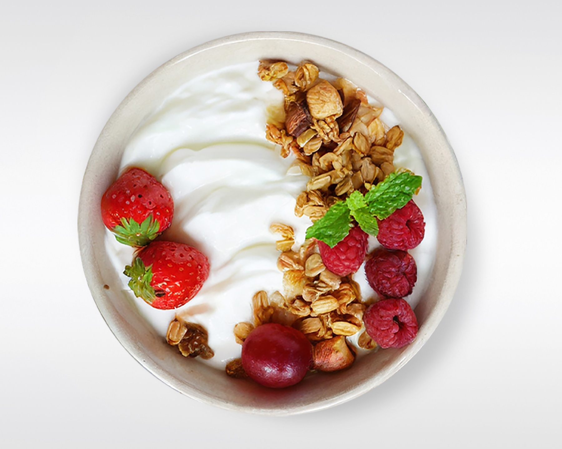 Image of Oatmeal with yogourt in a bowl and topped with strawberries and raspberries.